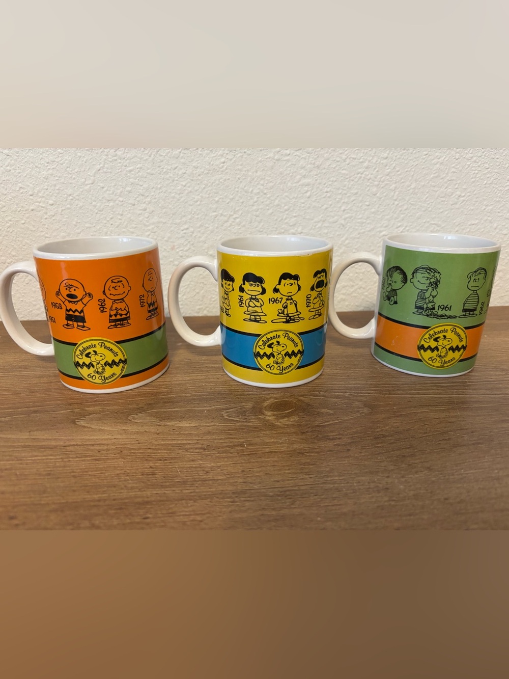 Peanuts Lucy,Charlie Brown, and Linus 60 year celebration mugs.